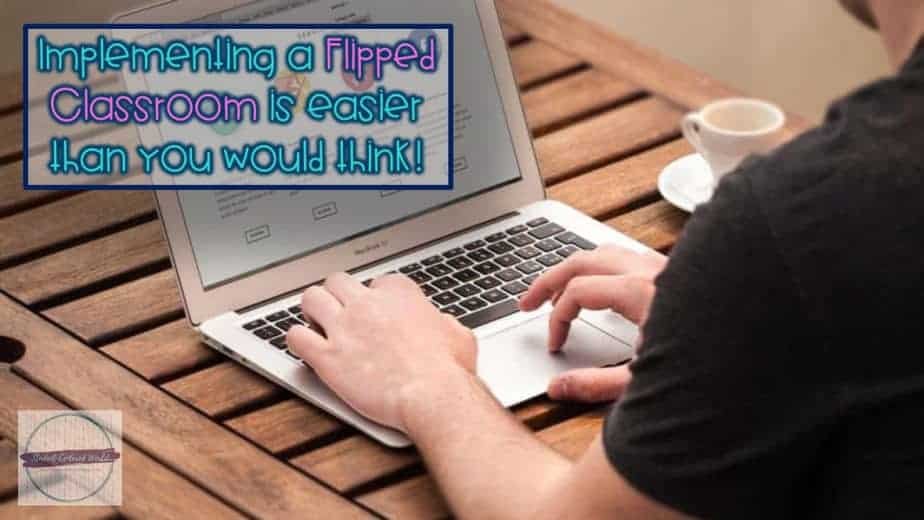 A person is typing on a laptop at a wooden table with a cup of coffee nearby. The screen displays a website, showing how implementing a Flipped Classroom is easier than you might think!