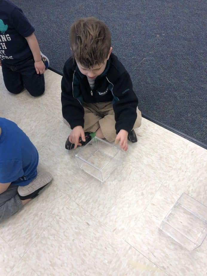 What Are Some Student-Centered Teaching Strategies child working on project on the classroom floor