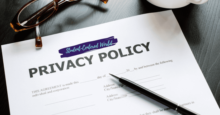 A Privacy Policy document on a dark wooden table with a pen and glasses nearby. The document is partially filled out.