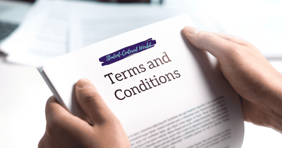 A person holding a document titled Terms and Conditions with the phrase Student-Centered World written above it in blue. The background shows a blurred desk with papers.