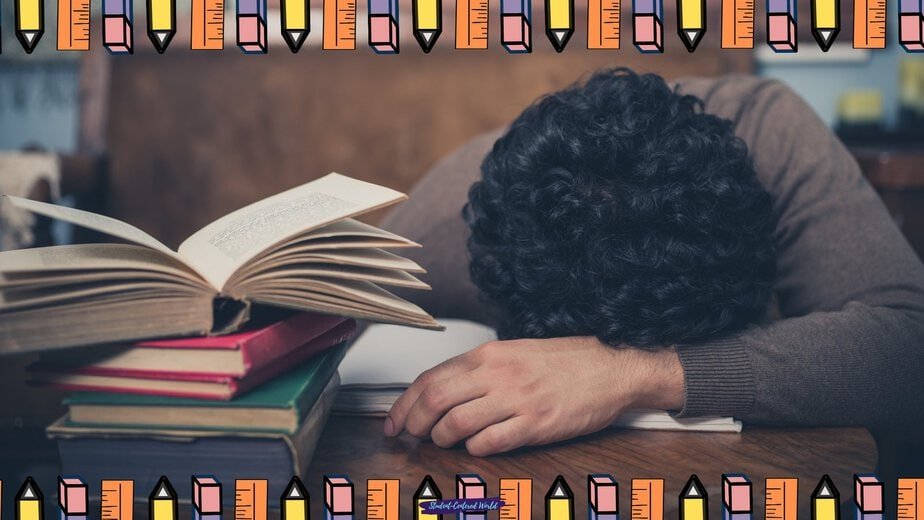 A person with curly hair rests their head on a desk beside open books and stacked notebooks, looking exhausted—perhaps pondering how do you handle uninterested students. The image is framed with a colorful pencil and ruler border.