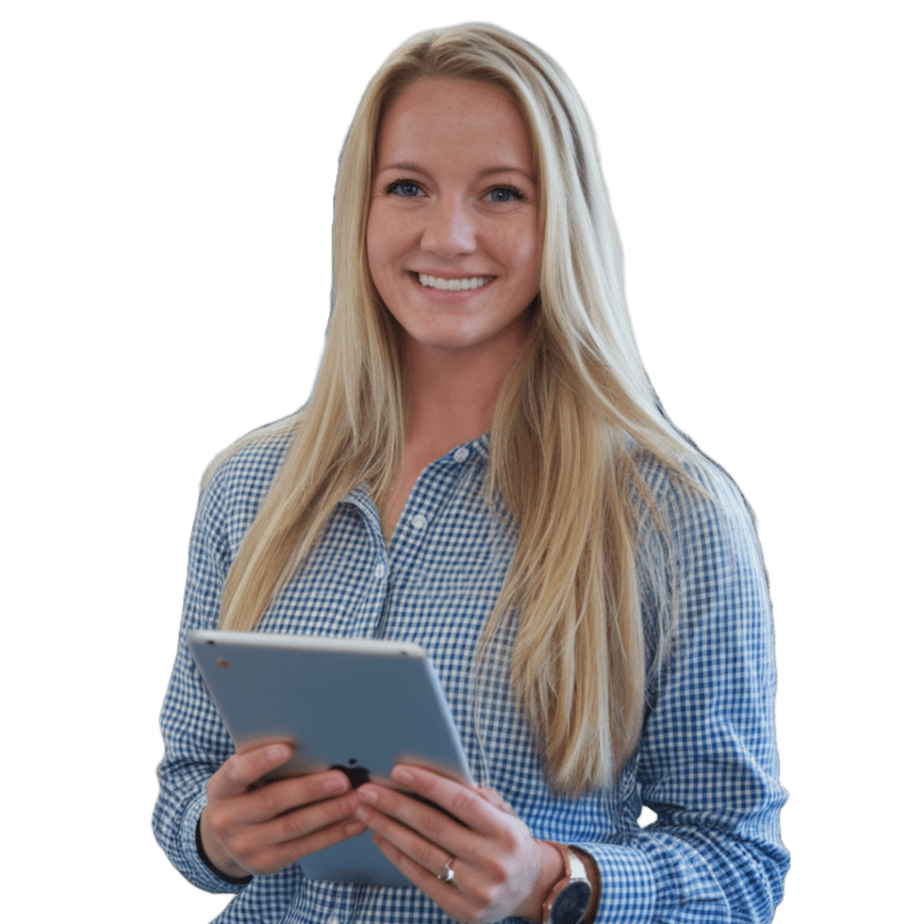 Smiling woman with long blonde hair, wearing a blue checkered shirt, holds a tablet in her hands. She stands against a plain background.