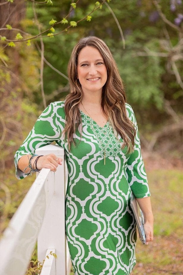 Jenn Breisacher outdoors in a green dress, smiling