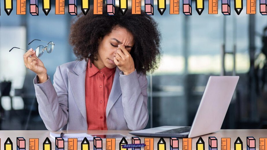 A woman sits at a desk with a laptop, holding her glasses in one hand and pinching the bridge of her nose, appearing stressed. The image is framed with a border of cartoon pencils.